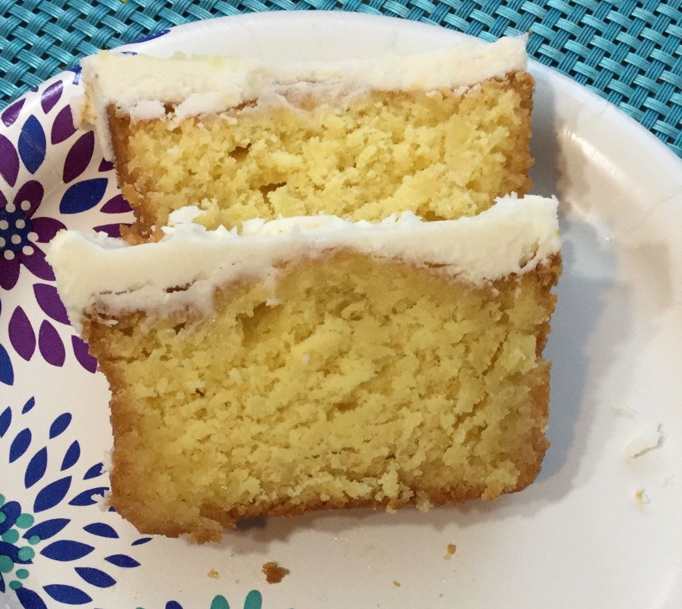 Two thick slices of Janet's golden rum cake with white frosting