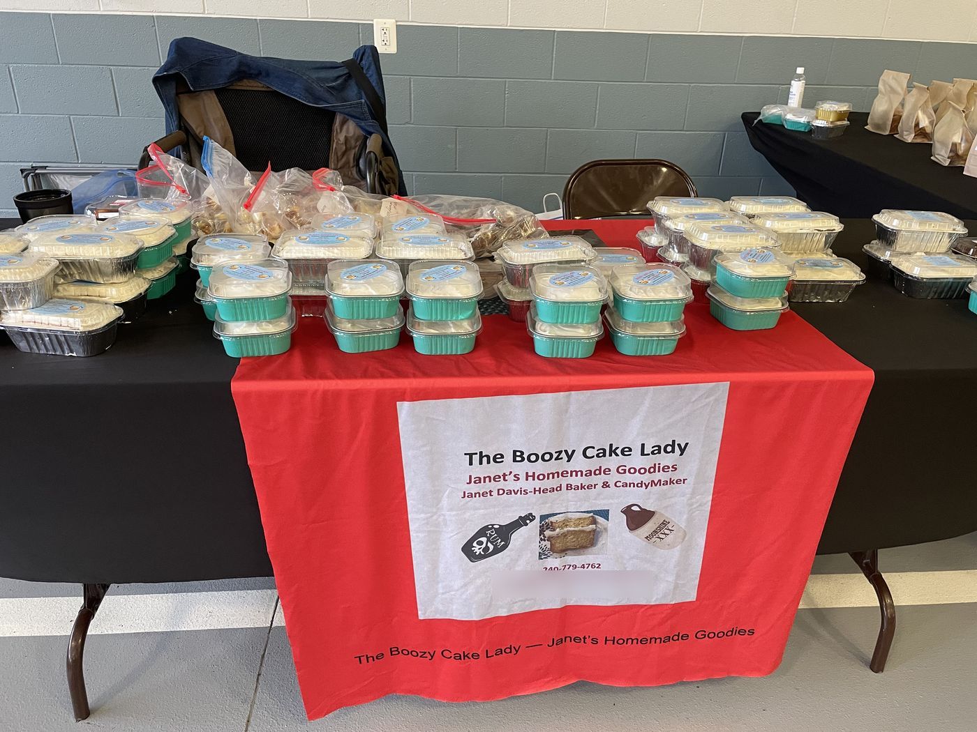 Janet's festival stand stacked with fresh cakes in mint-green pans